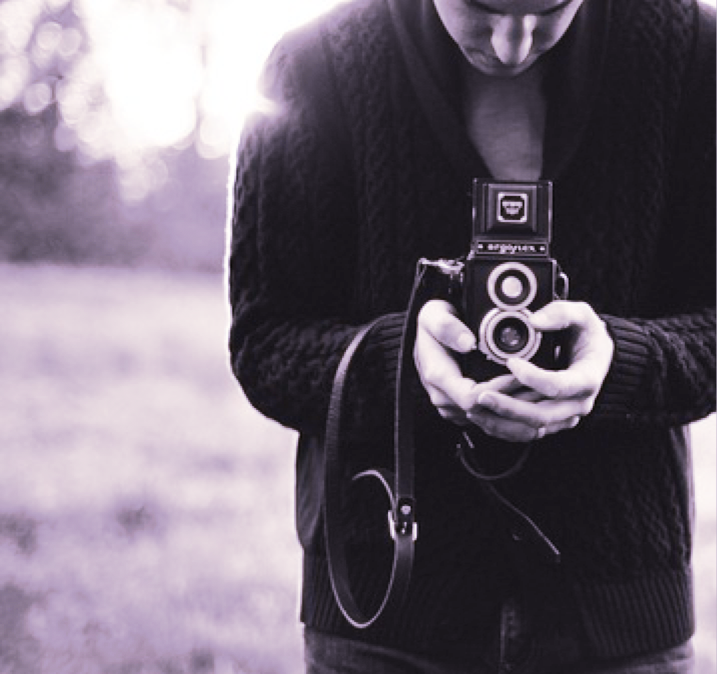 Photo of a man holding a camera